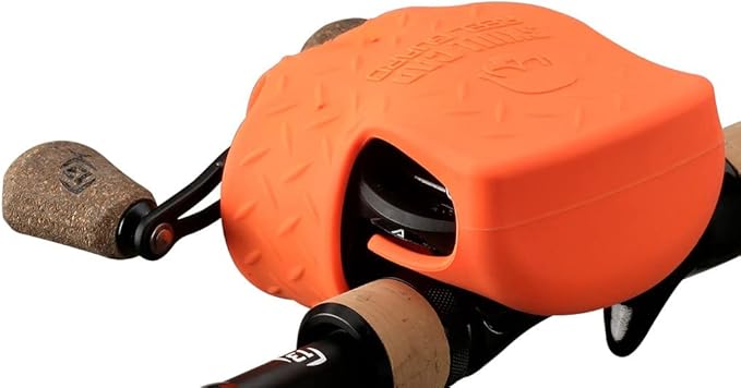 Orange fishing reel with cork handles on a white background