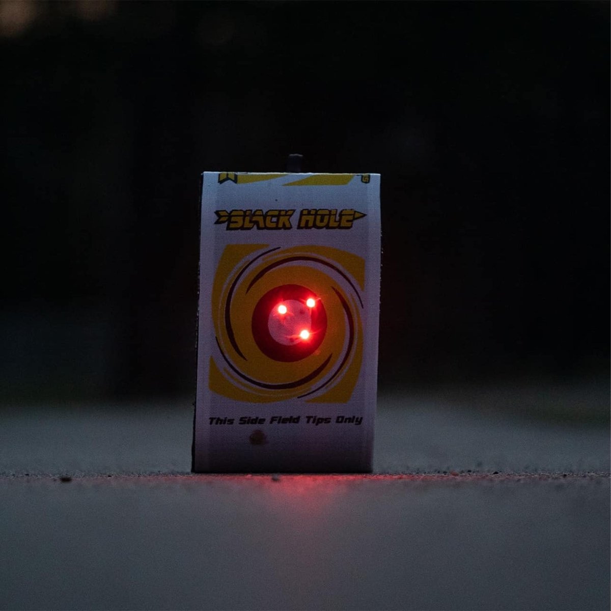Archery target with a red light on a dark background