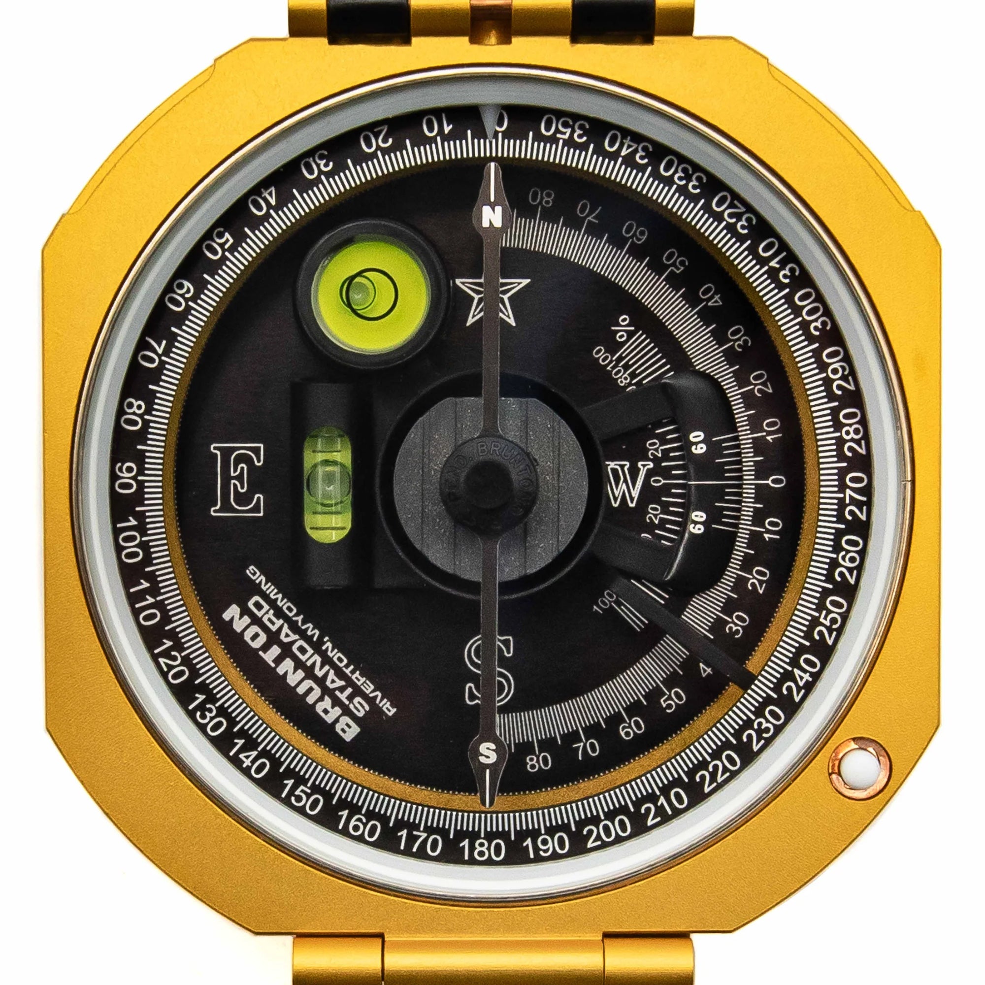 Gold compass with black dial and green accents on a white background