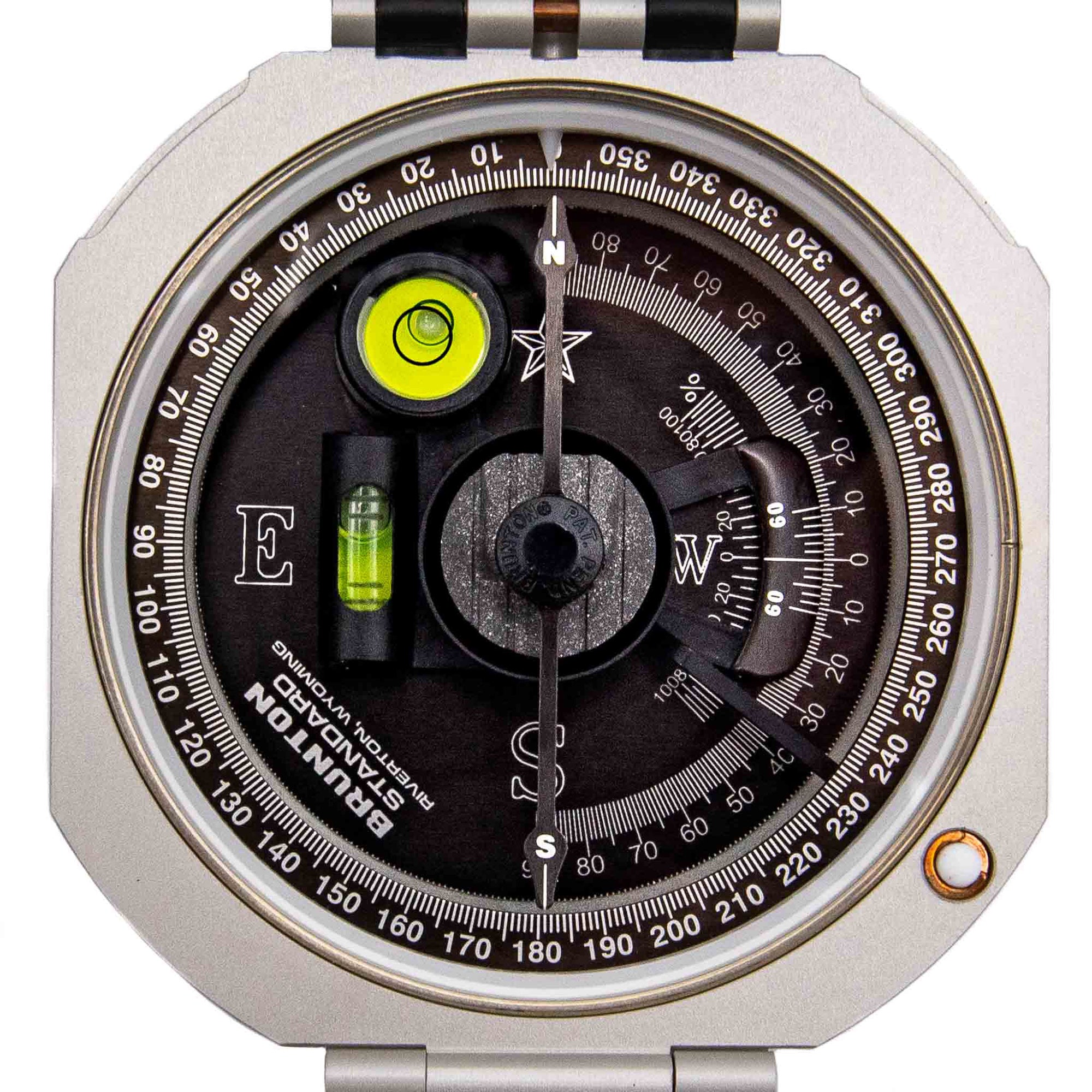 Compass with silver casing and black dial on a white background