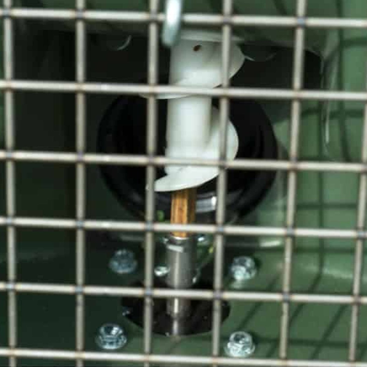 Close-up of a tripod feeder diller mechanical component with a grid overlay