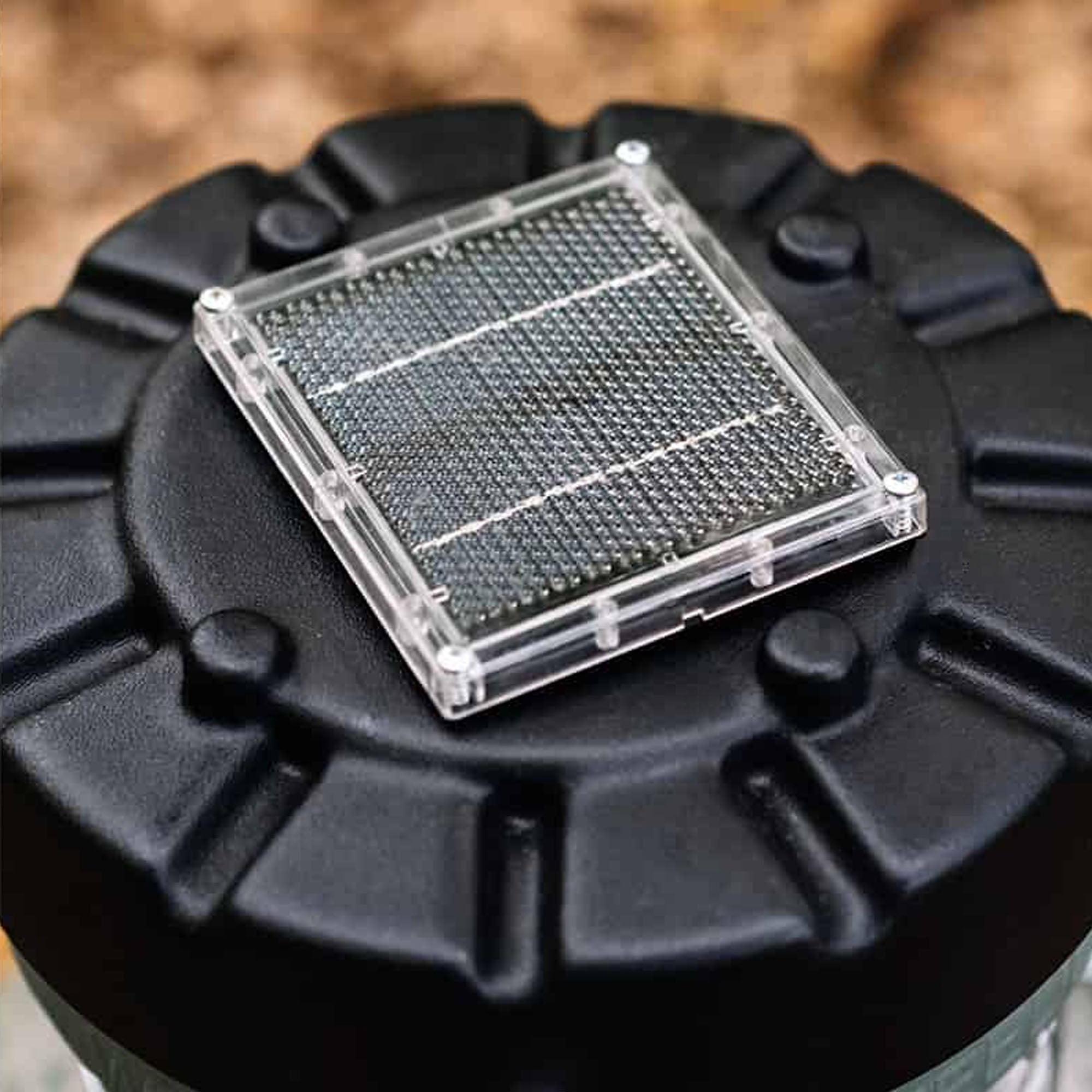 Clear grid on a black circular object with a blurred background