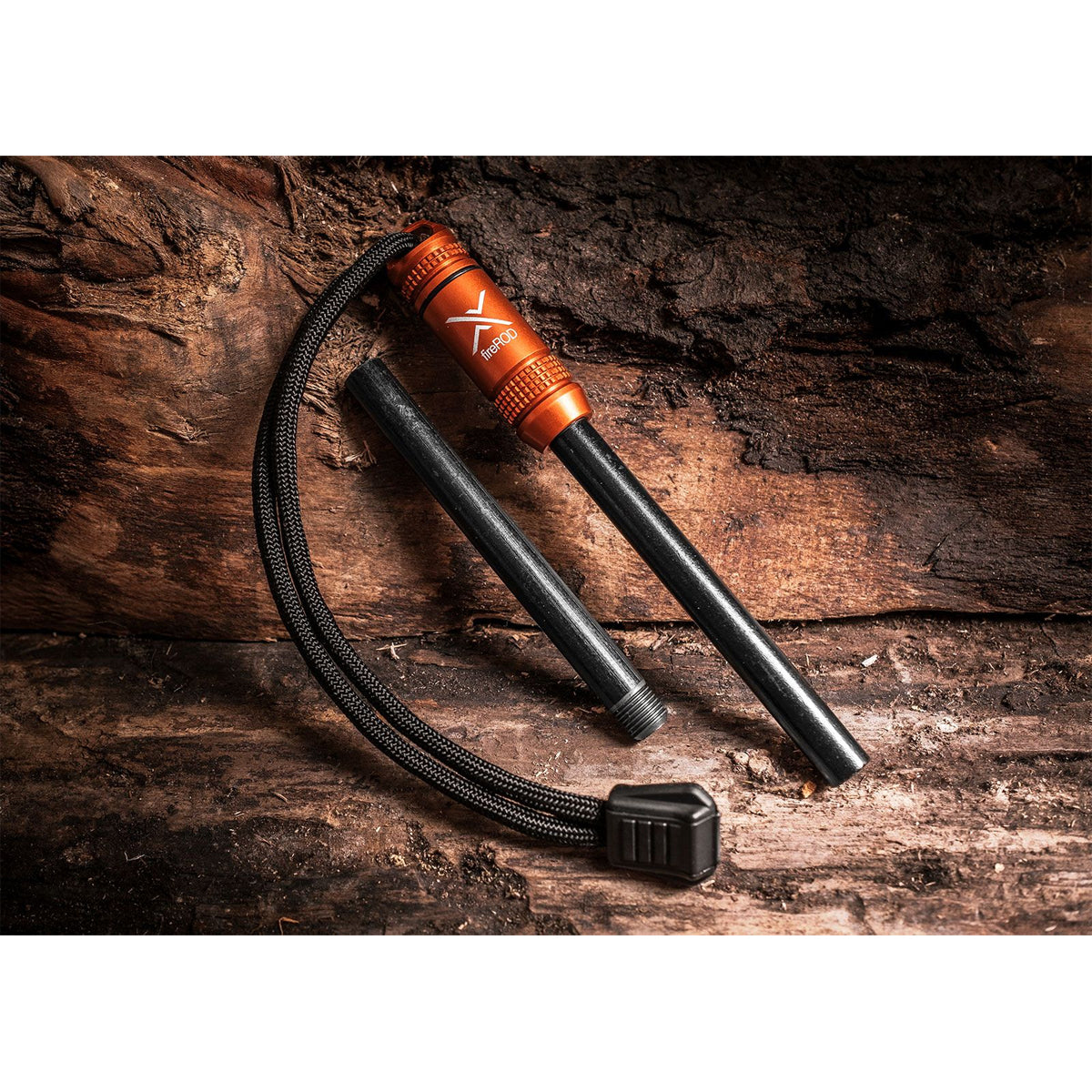 Fire starter tool with orange handle and black body on a wooden surface