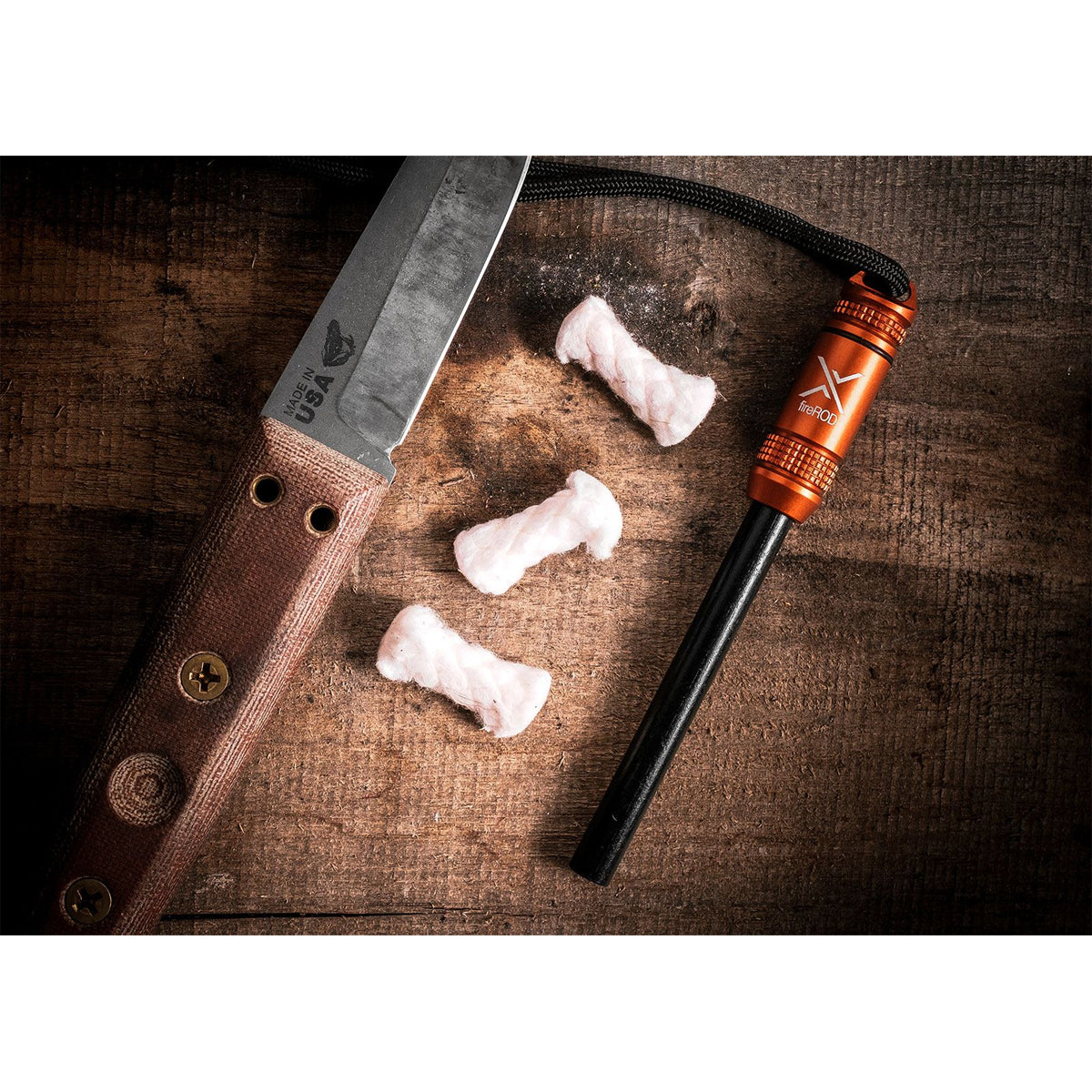 Knife, fire starter, and raw meat on a wooden surface