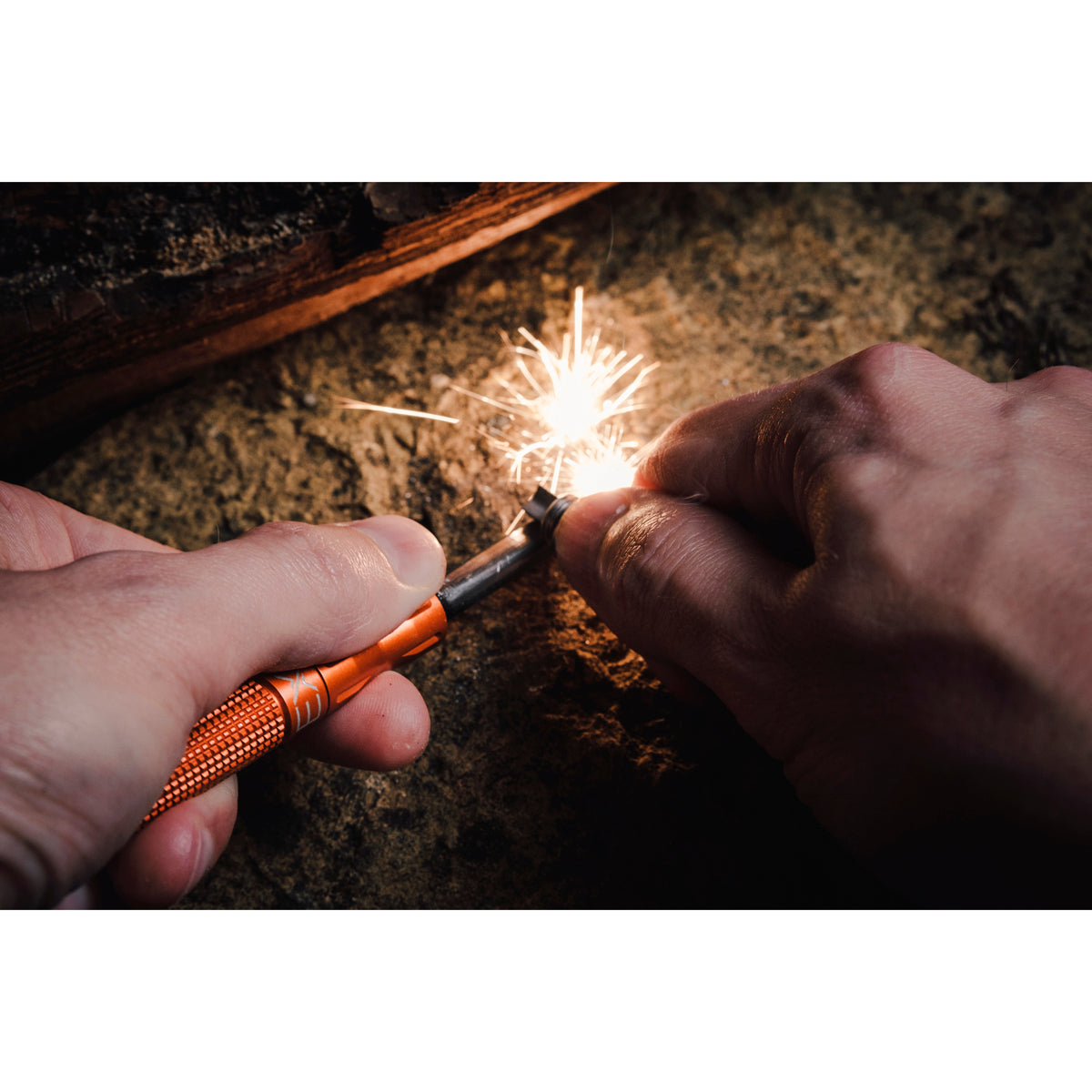 Person igniting a sparkler with a Exotac nanoSTRIKER XL Ultra-Light Ferrocerium Rod Firestarter
