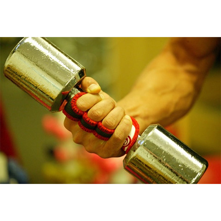 Hand holding a silver dumbbell with red and black grip tape against a blurred background