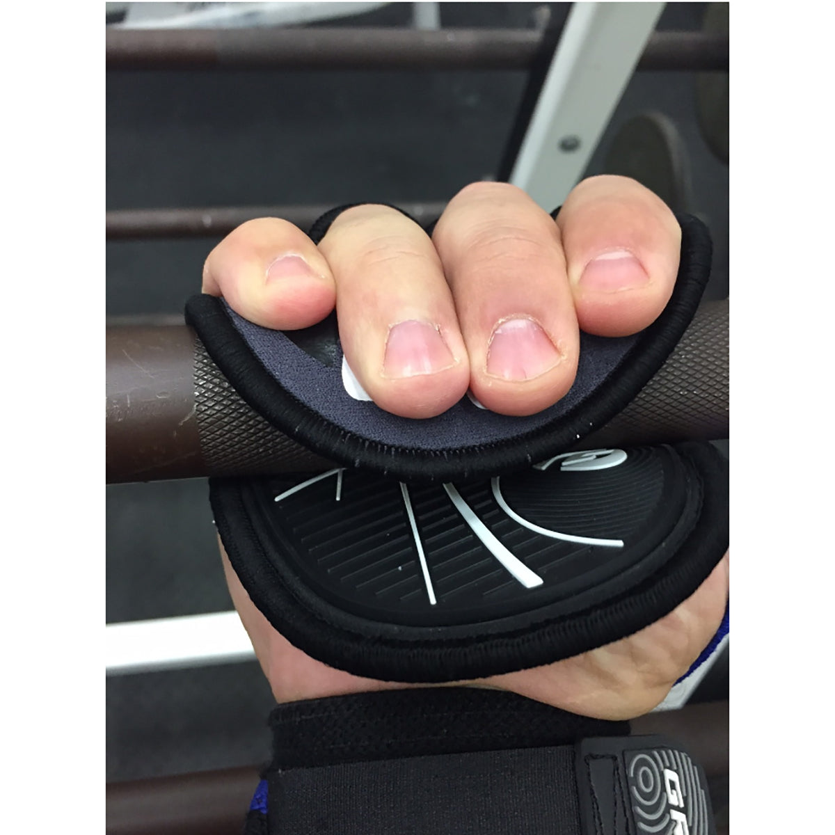 Hand holding a black grip handle with a car interior background