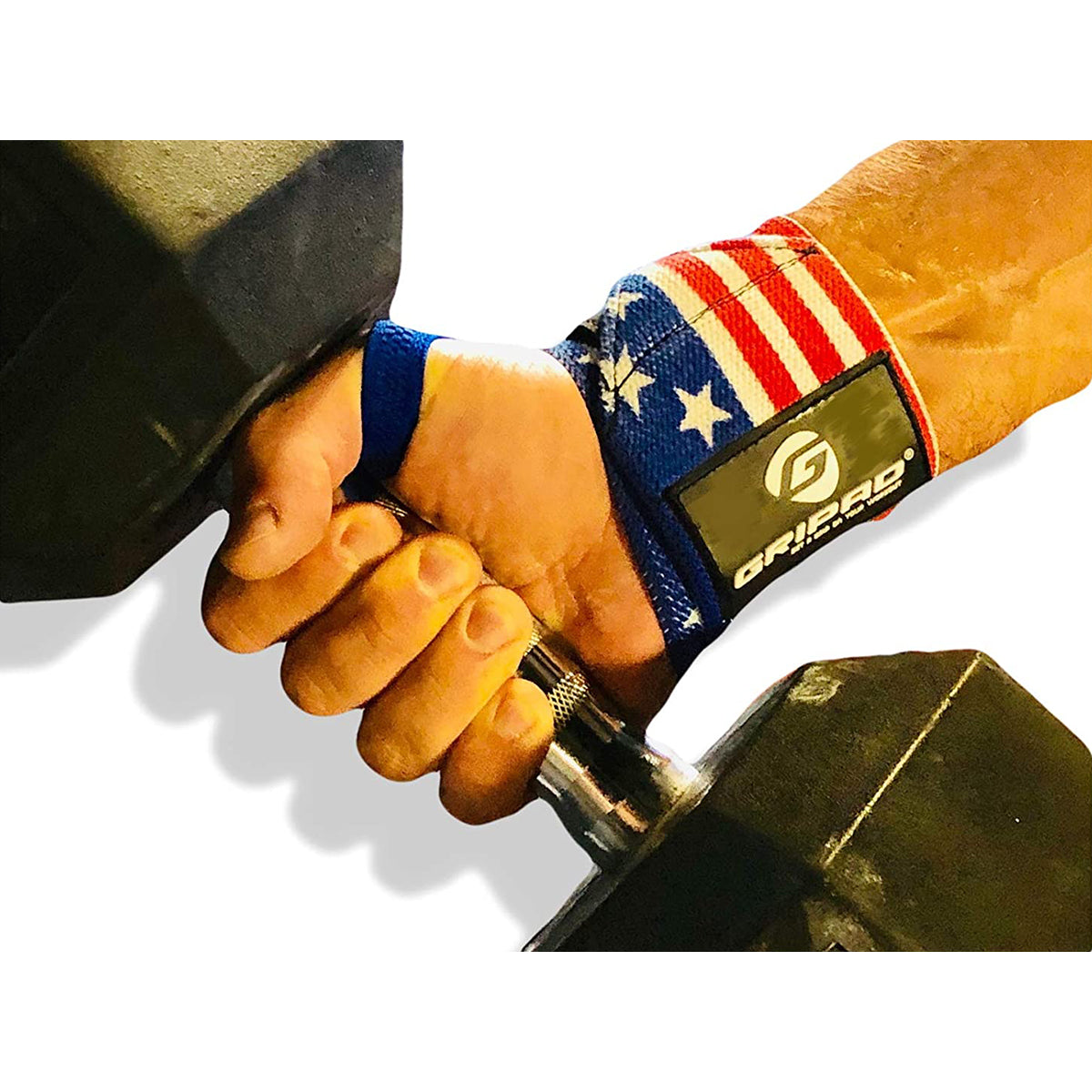 Hand holding a dumbbell with a wrist wrap featuring an American flag design and a brand logo.