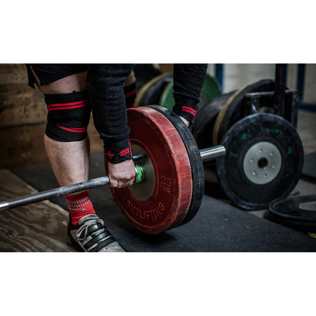 Person lifting a barbell with wrist support brace for weightlifting