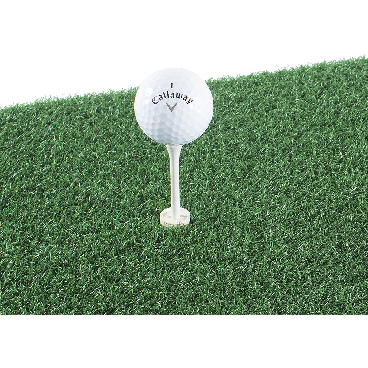 Golf ball on a tee with Callaway logo on a green grass hitting golf mat background