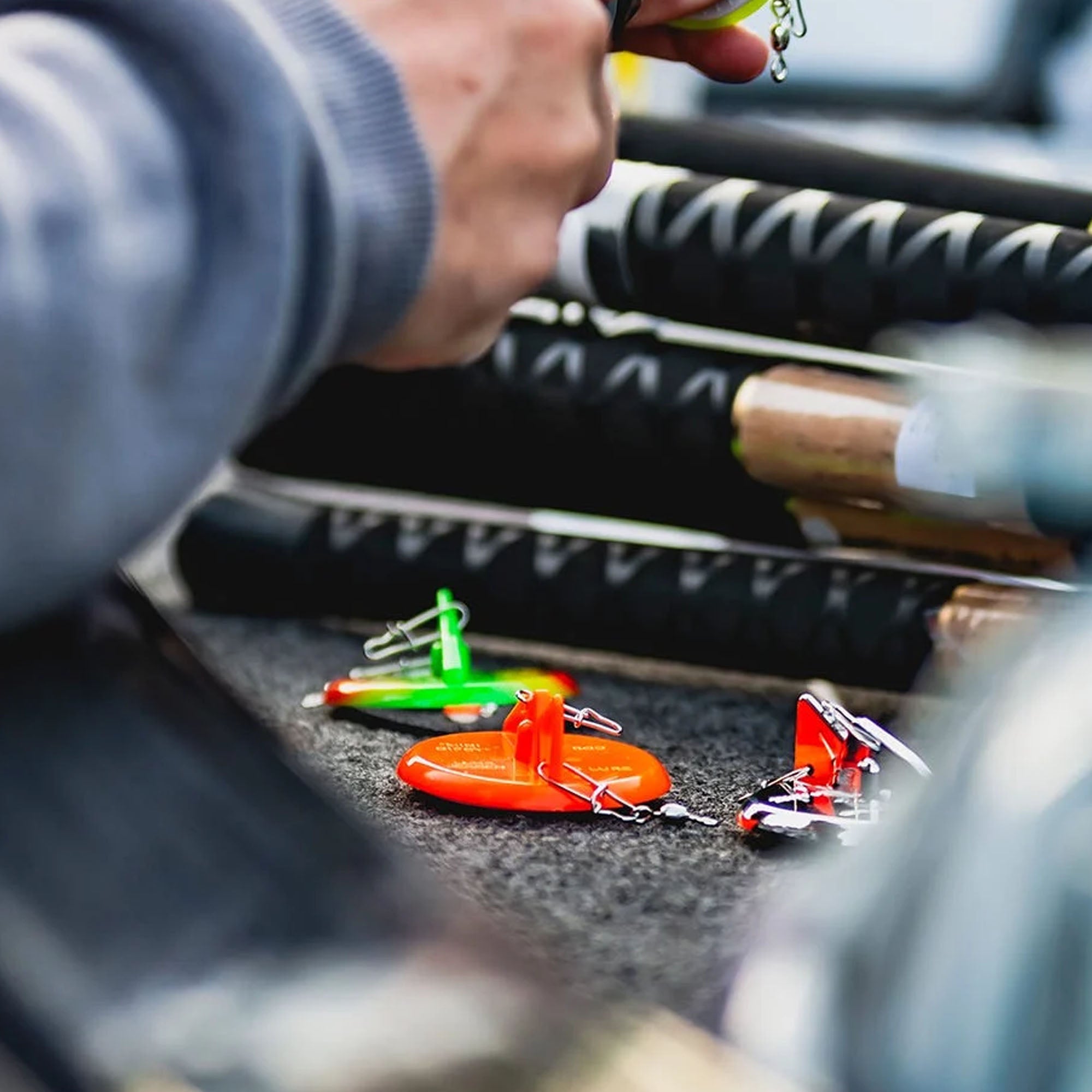 Close-up of fishing lures on a fishing rod with blurred background