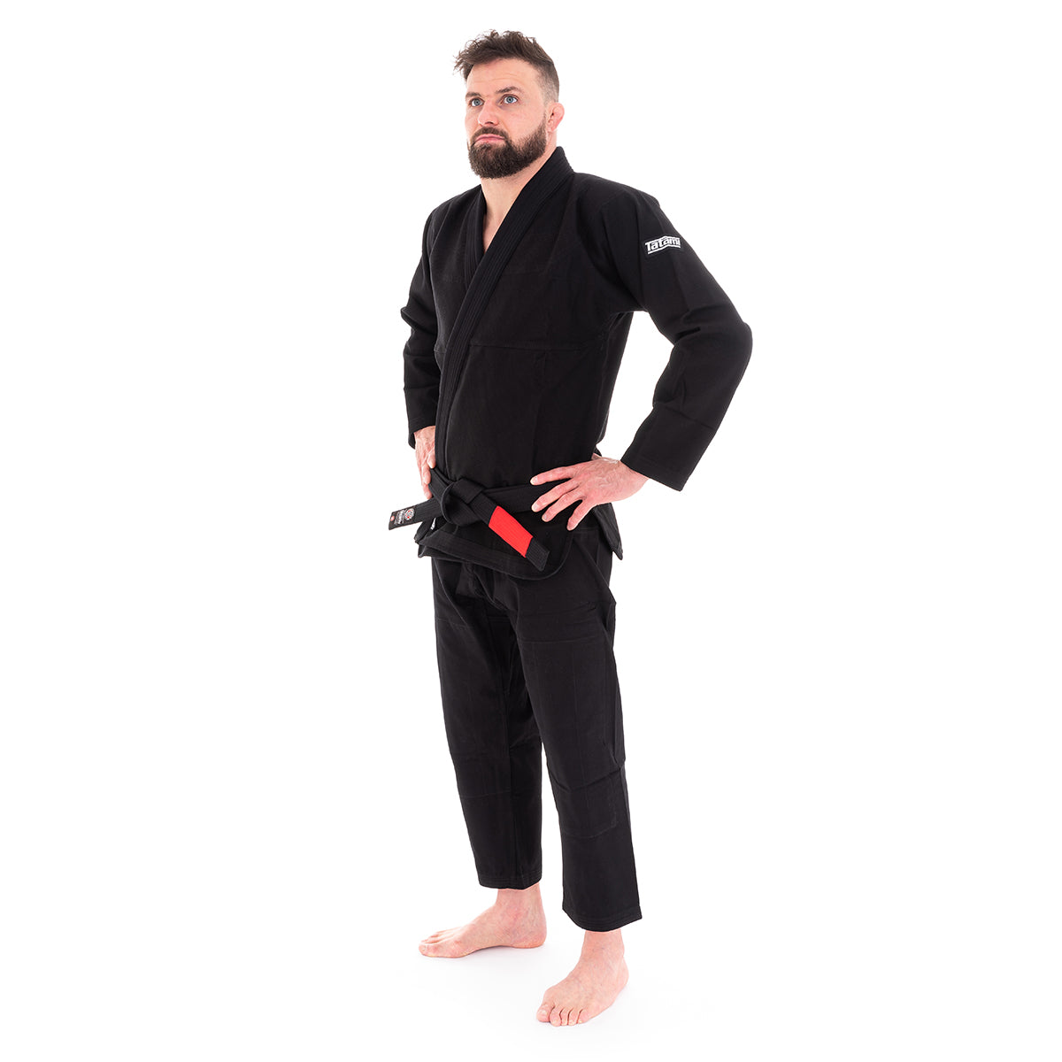 Man wearing a black martial arts uniform on a white background