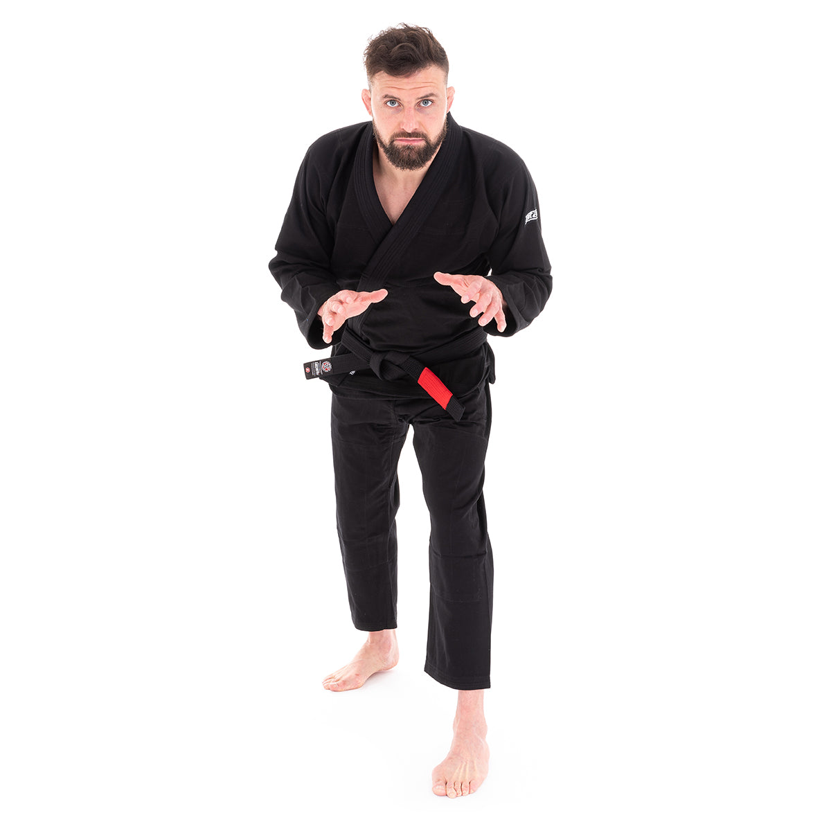 Man wearing a black martial arts uniform on a white background