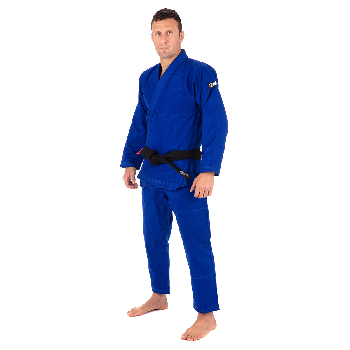 Man wearing a blue martial arts uniform on a white background