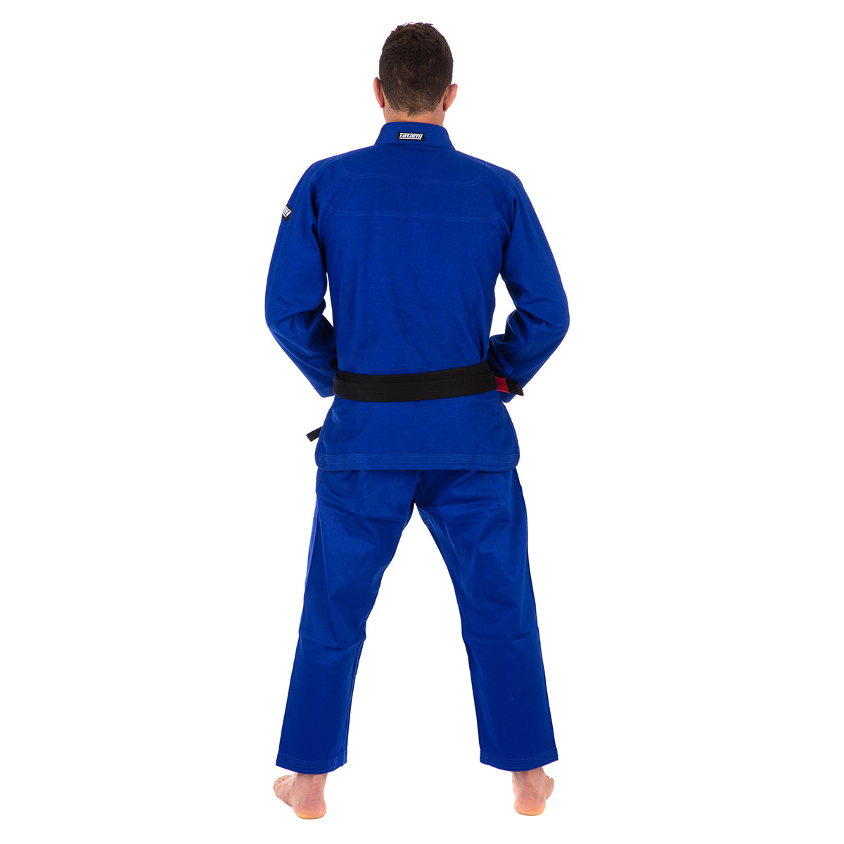 Person wearing a blue martial arts uniform on a white background