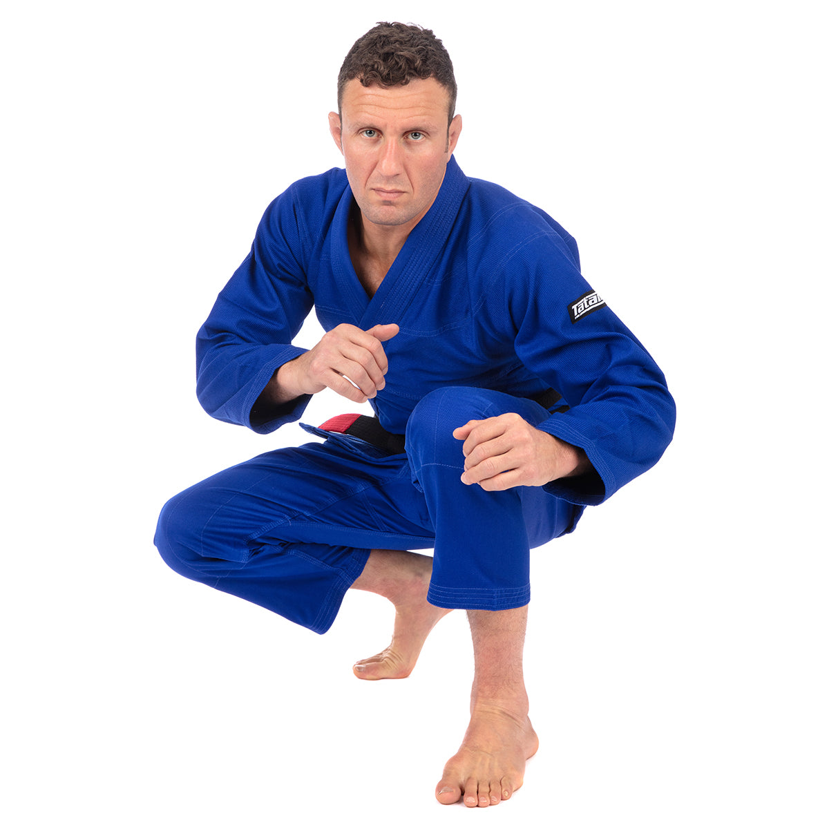 Man wearing a blue martial arts uniform on a white background