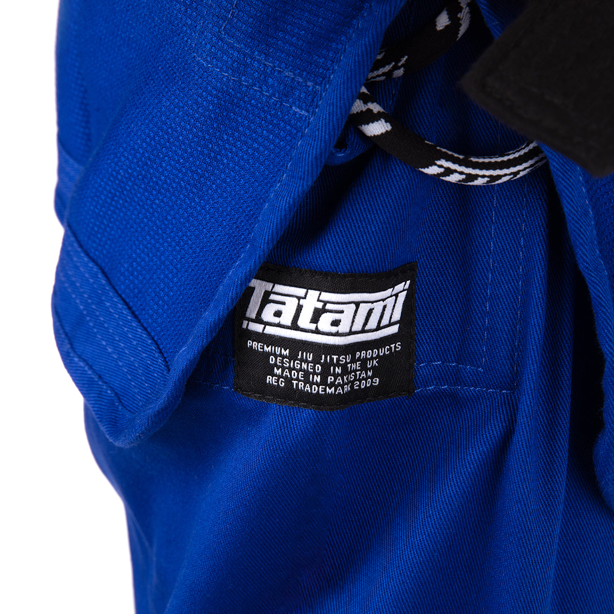 Blue martial arts gi with a visible Tatami label on a white background