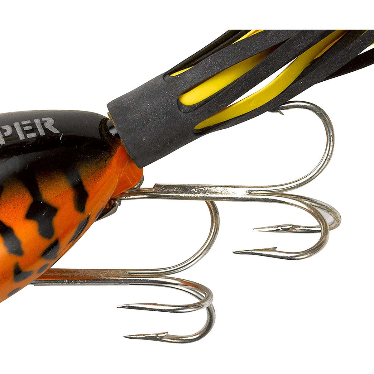 Close-up of a fishing lure with orange, black, and yellow colors on a white background.