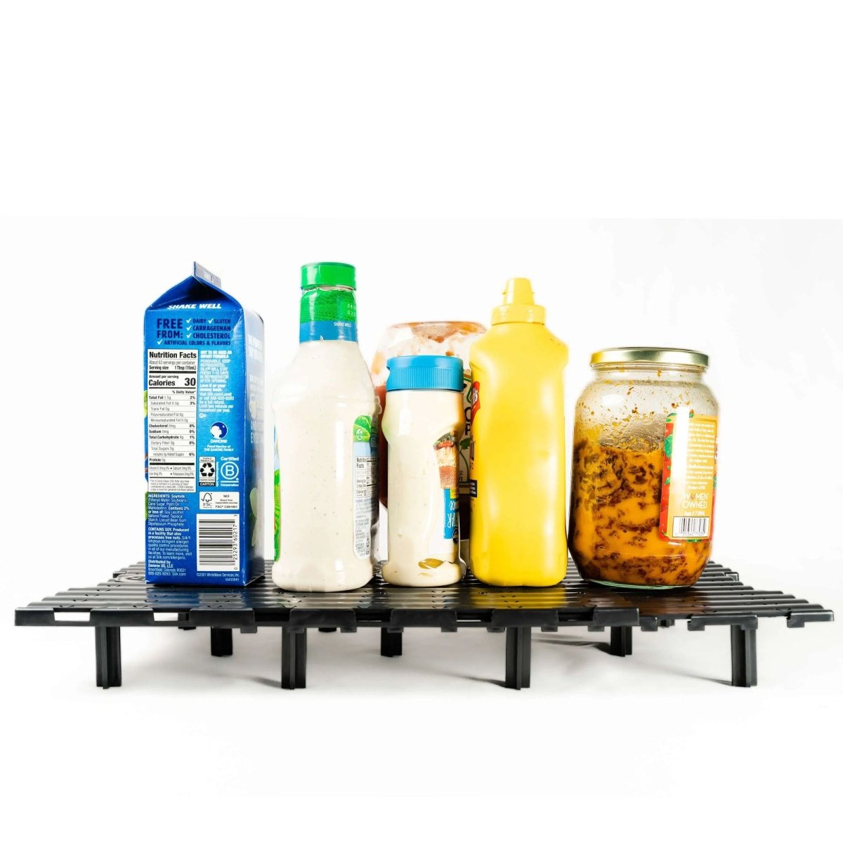 Blackcooler tray holding various food items on a white background
