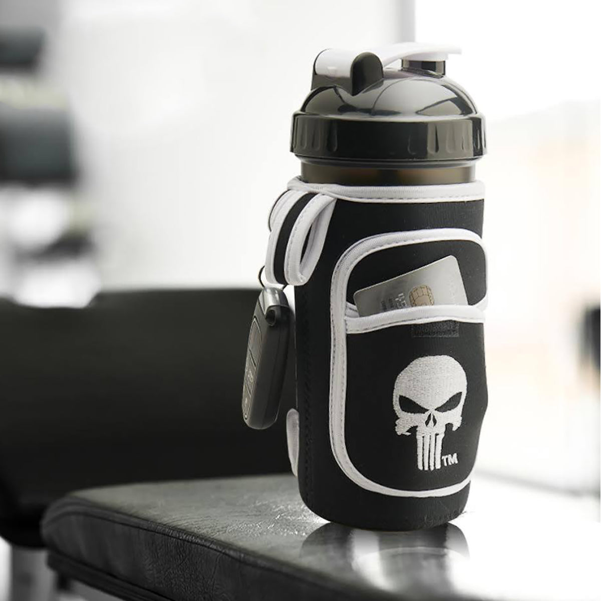 Black and white water bottle with Punisher logo on a blurred background