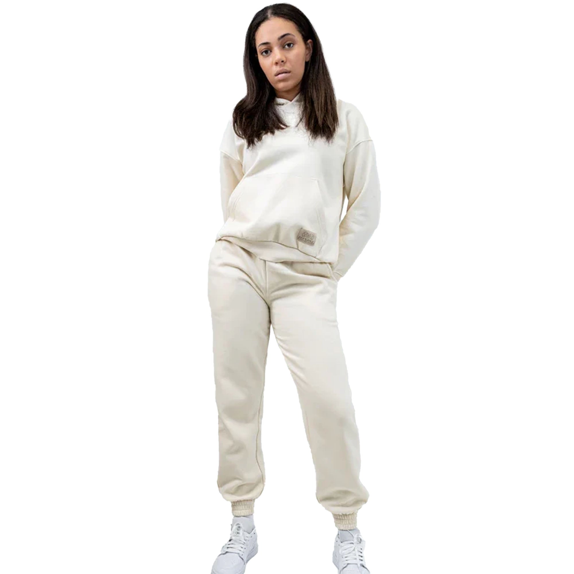 Person wearing a beige heavyweight fleece hoodie tracksuit on a white background