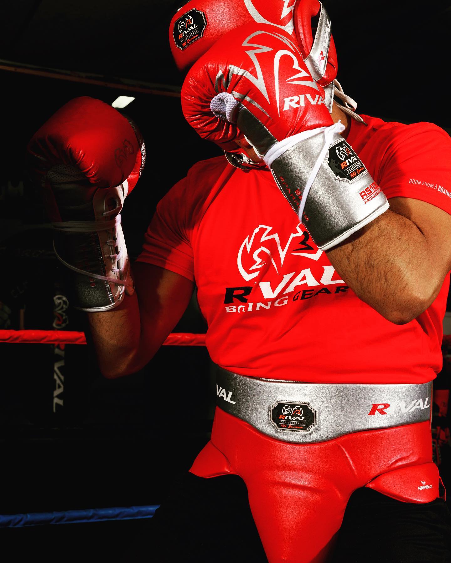 Person in red boxing gear with Rival branding in a boxing ring - Forza Sports
