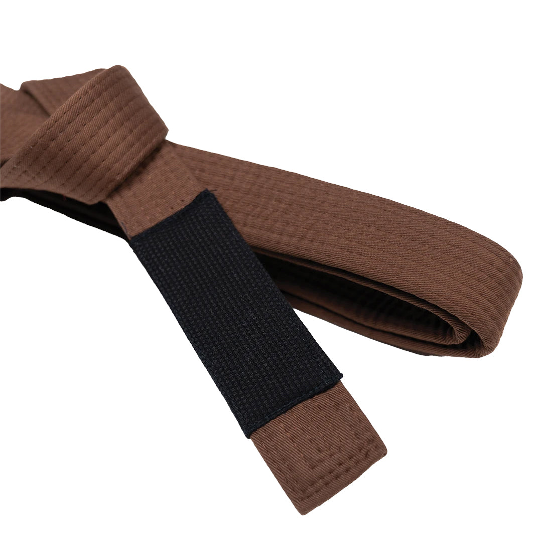 Brown belt with a black strap on a white background