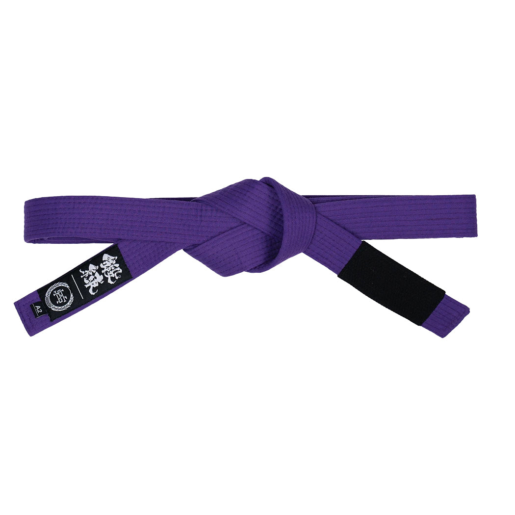 Purple martial arts belt with a black patch on a white background