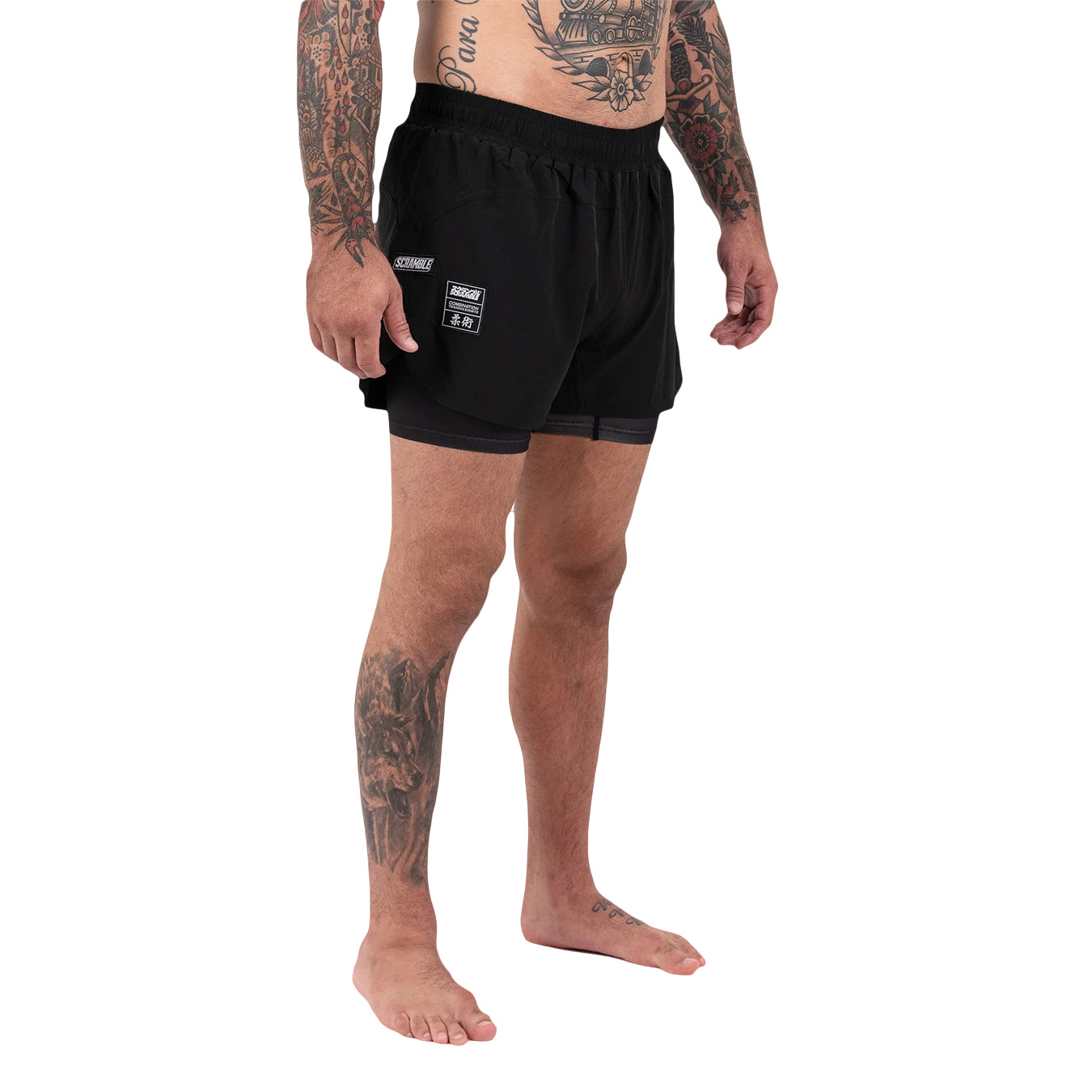 Person wearing black athletic shorts with a visible brand logo on a white background