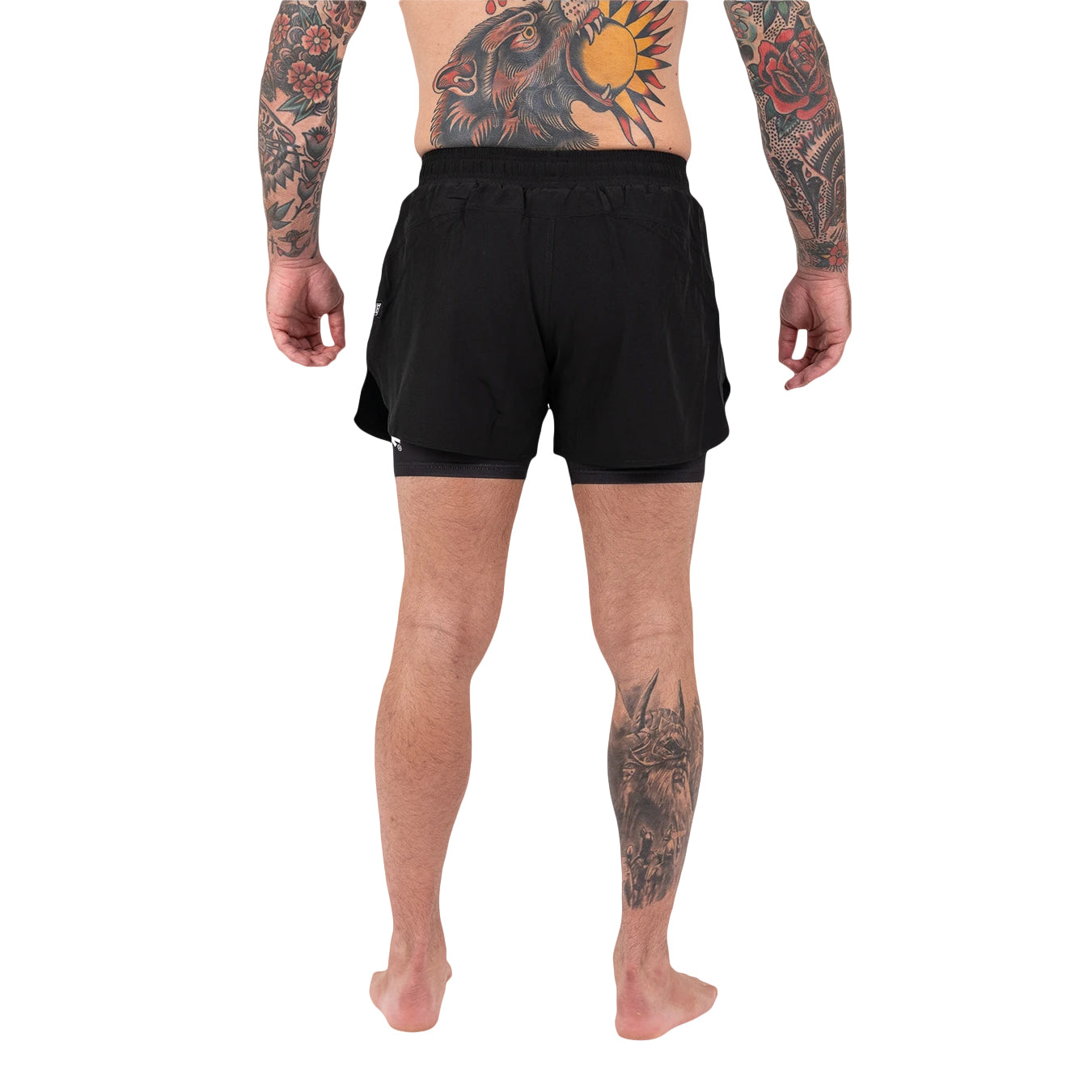 Person wearing black shorts on a white background