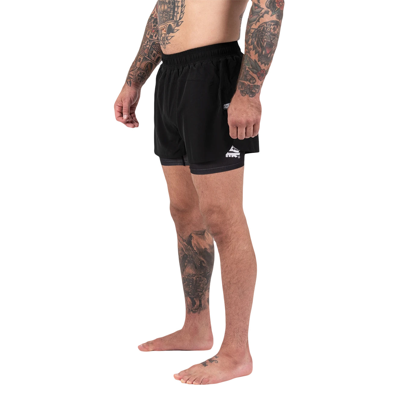 Person wearing black athletic shorts with a brand logo on a white background