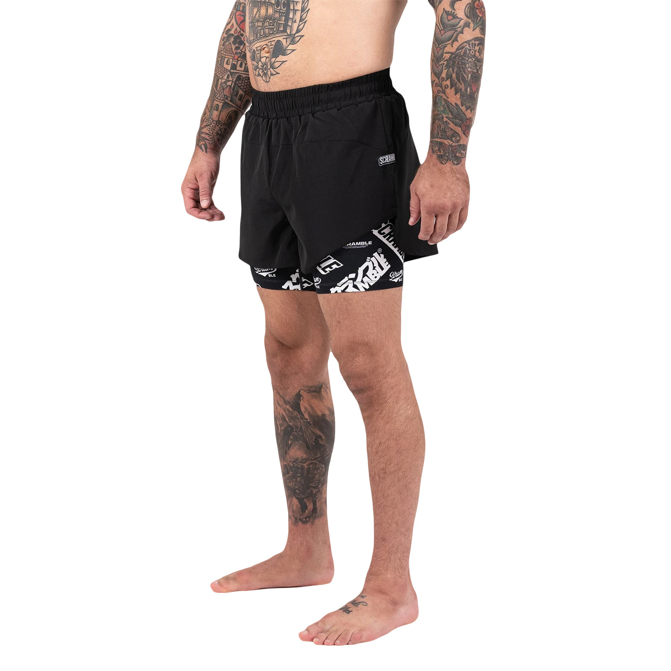 Person wearing black shorts with white patterns on a white background