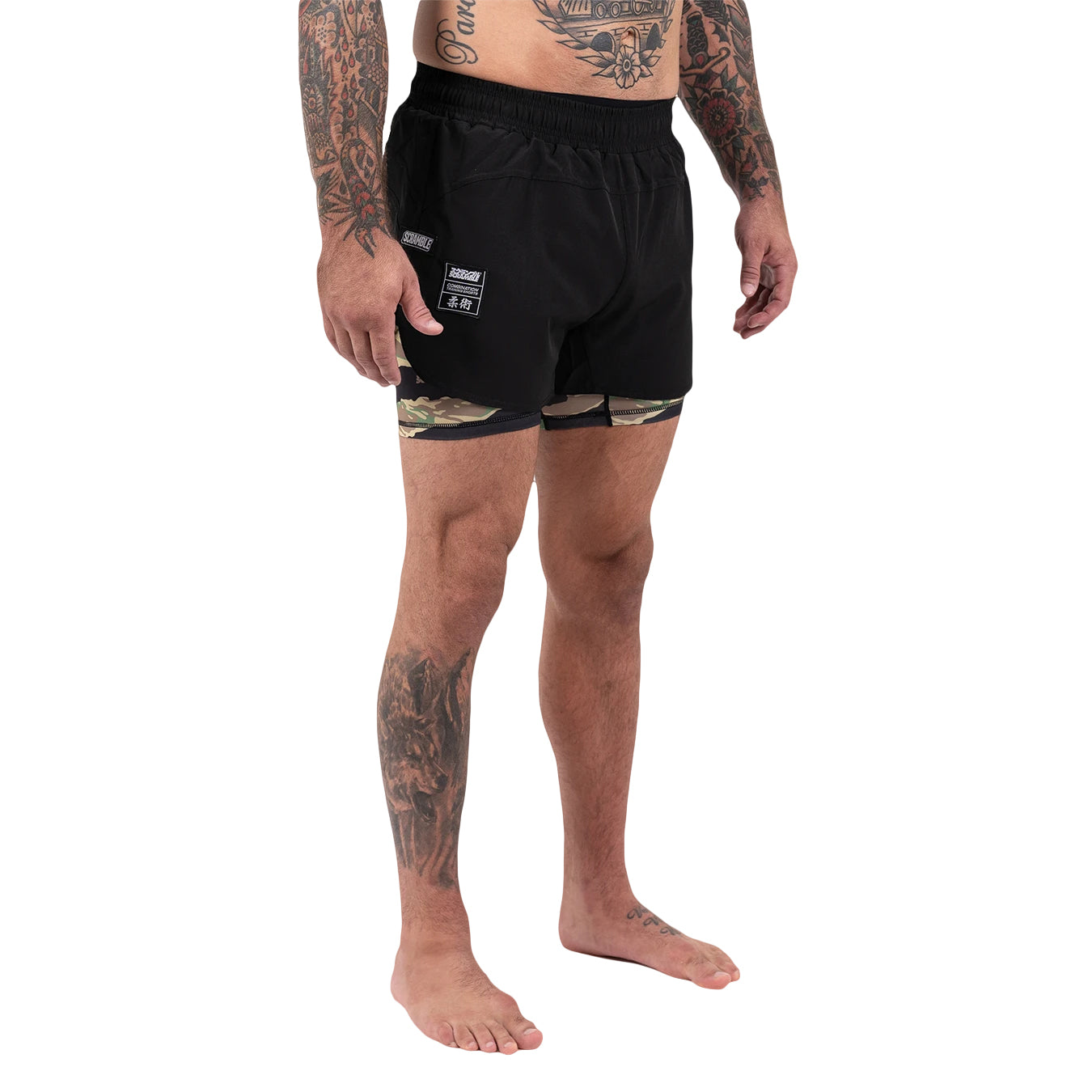 Person wearing black boxer briefs with camouflage design on a white background