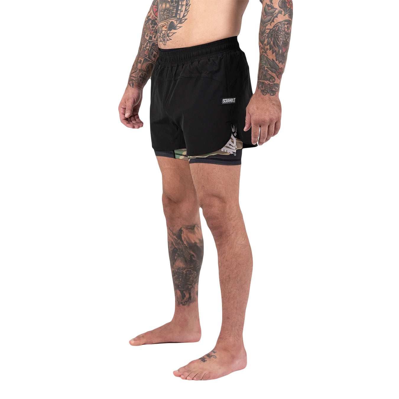 Person wearing black shorts with a brand logo on a white background