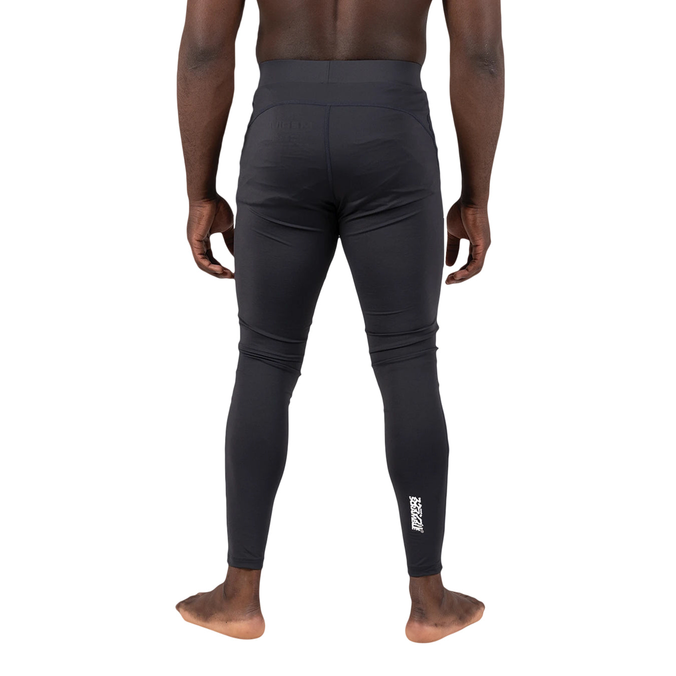 Person wearing black compression leggings on a white background