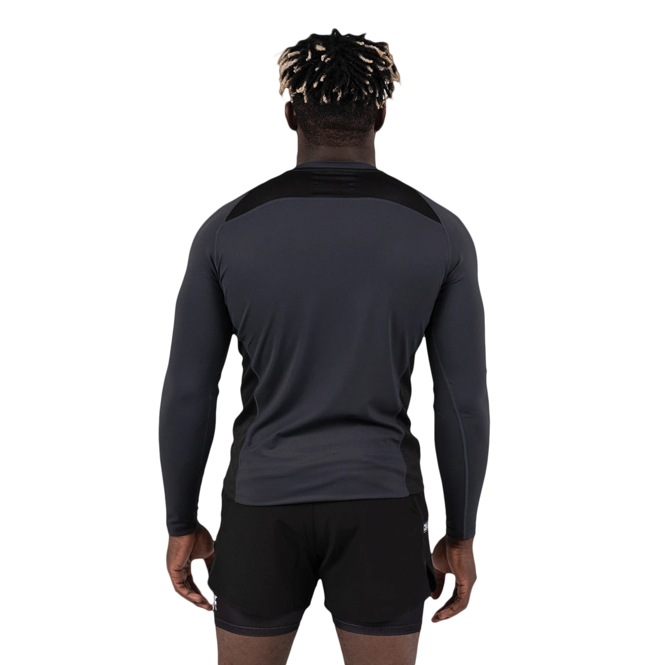 Person wearing a black long-sleeve athletic shirt and shorts on a white background