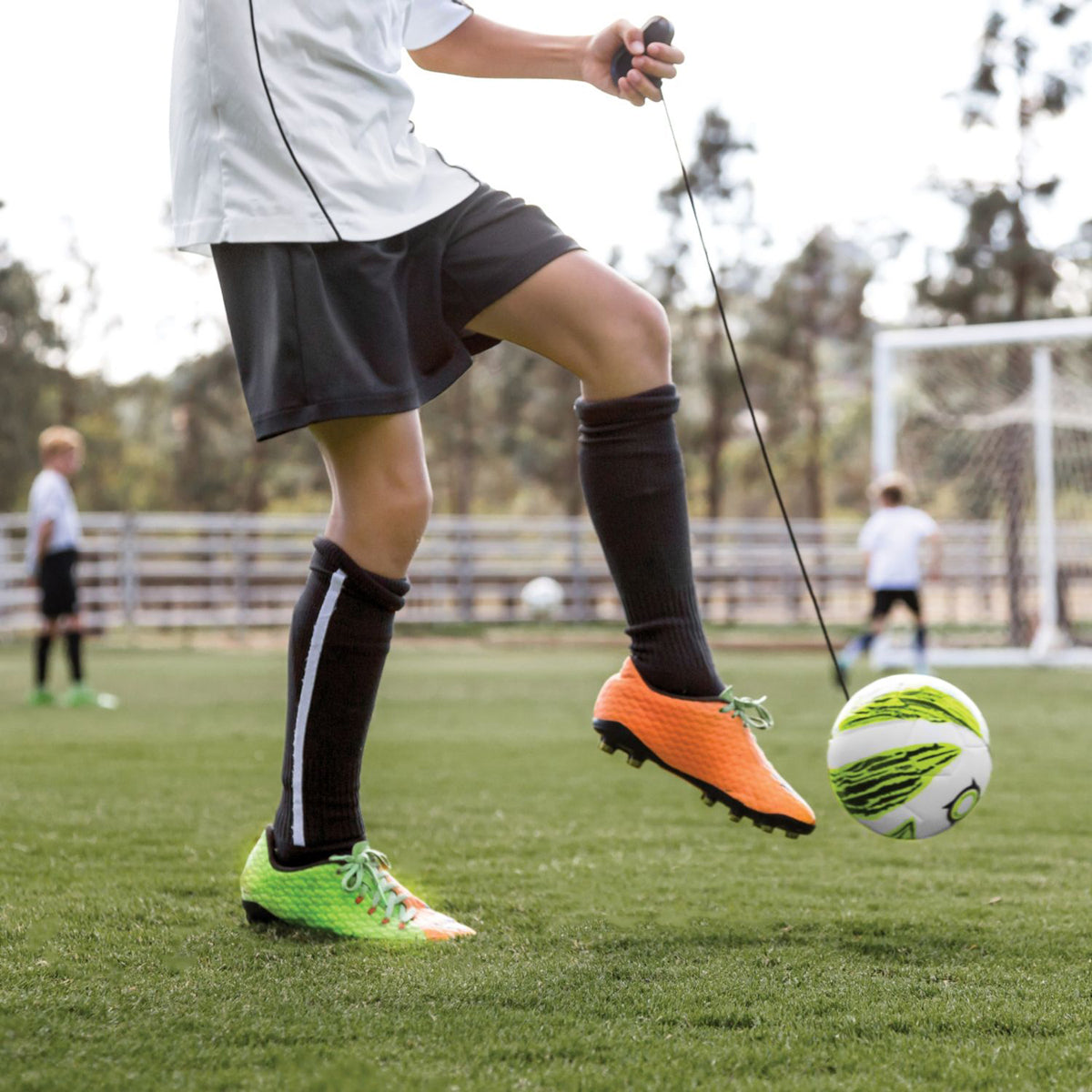 Person practicing soccer star kick touch trainer skills with a ball on a field