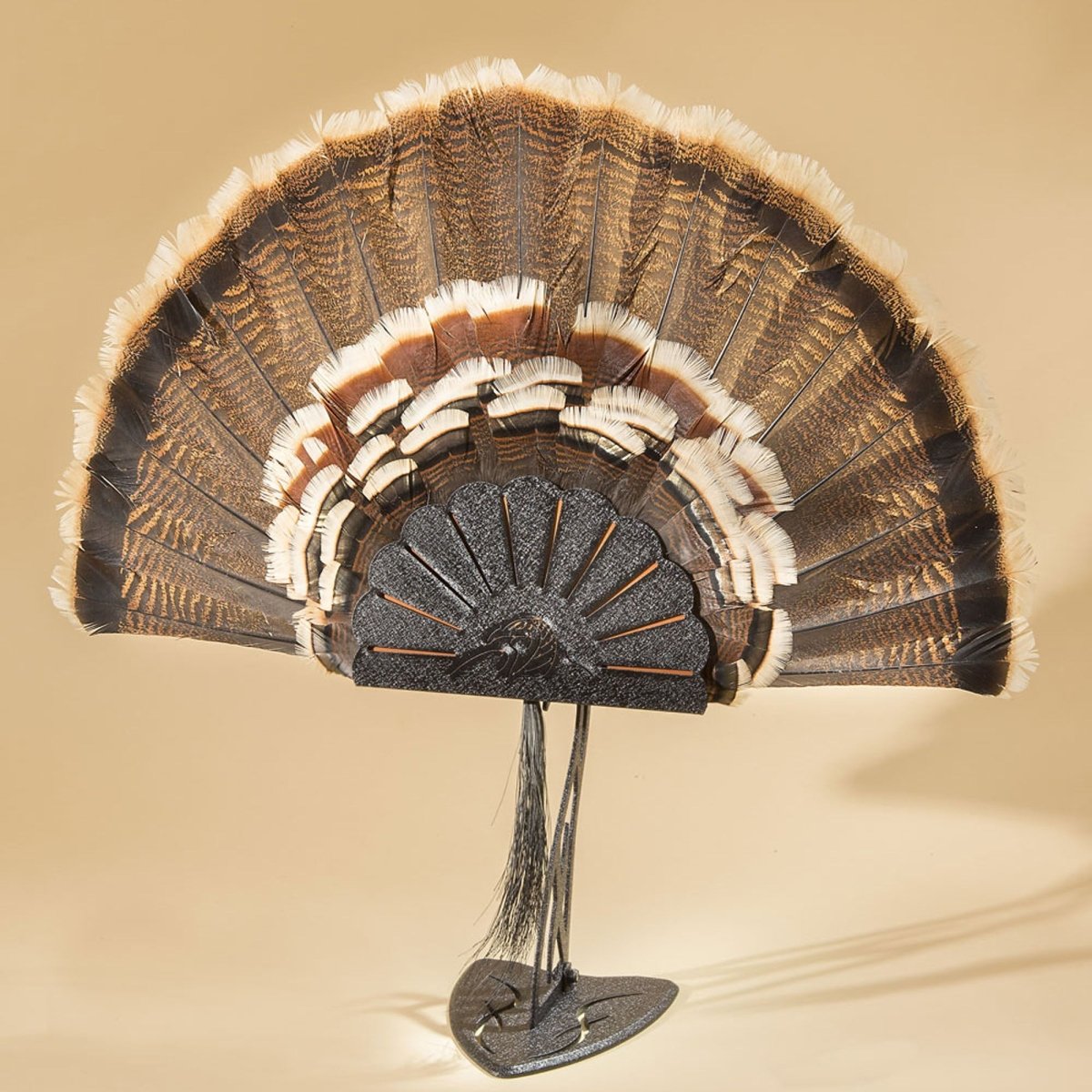 Decorative turkey hooker with feathered design on a beige background