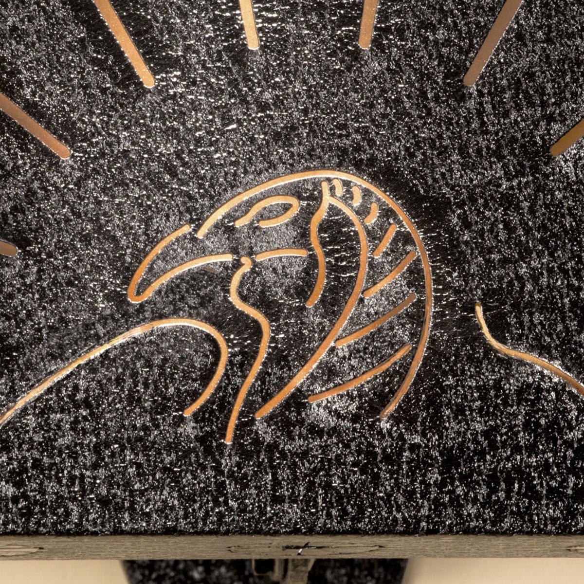 Close-up of a wooden surface turkey hooker with a carved animal figure.
