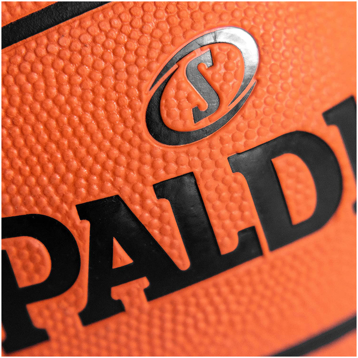 Close-up of an orange basketball with a visible Spalding logo - Forza Sports