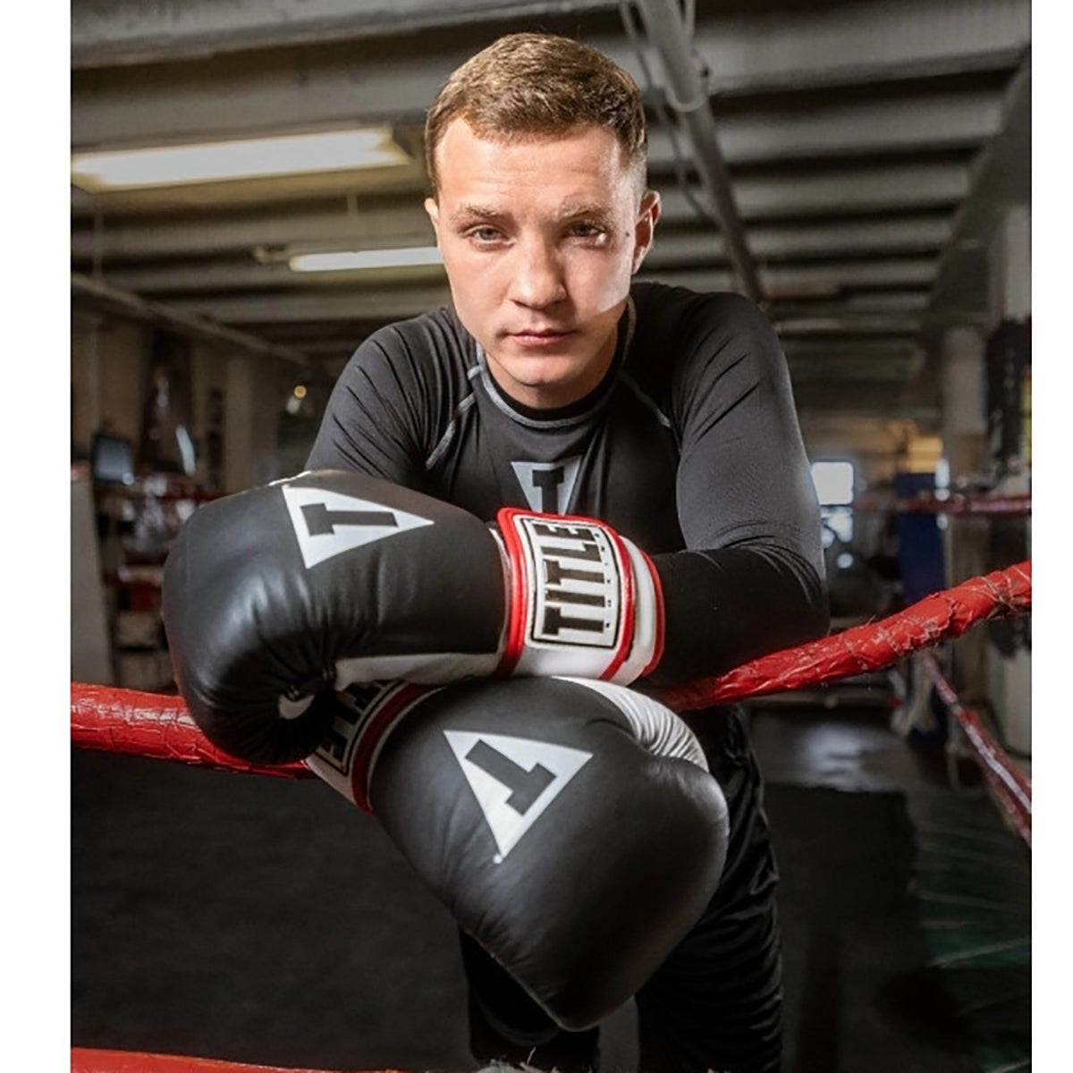 Person wearing boxing gloves in a boxing ring