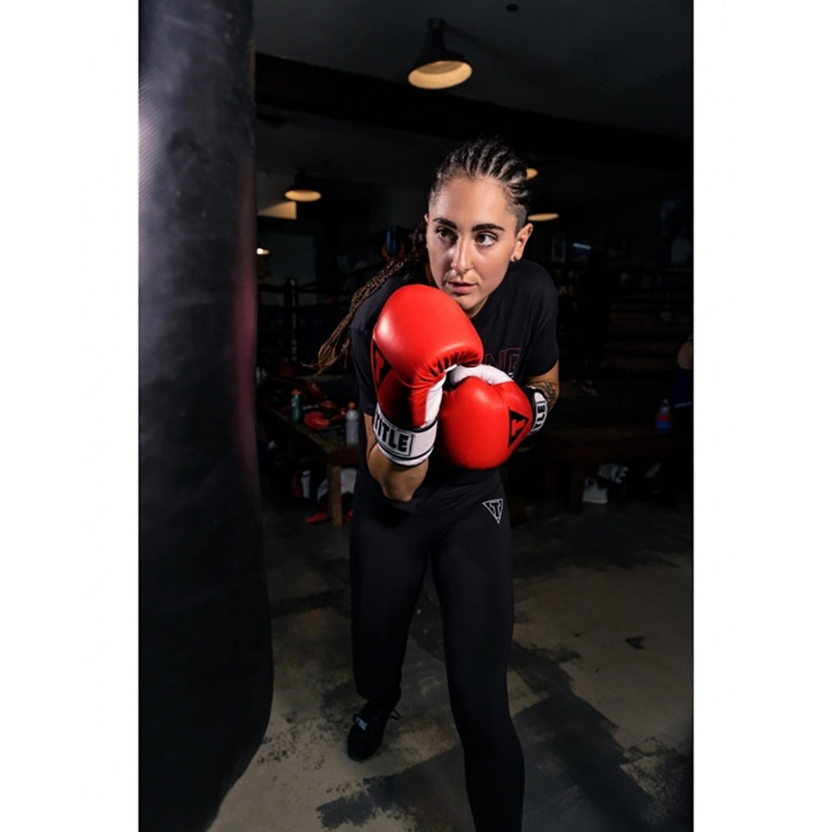 Person wearing red title boxing gel world bag gloves