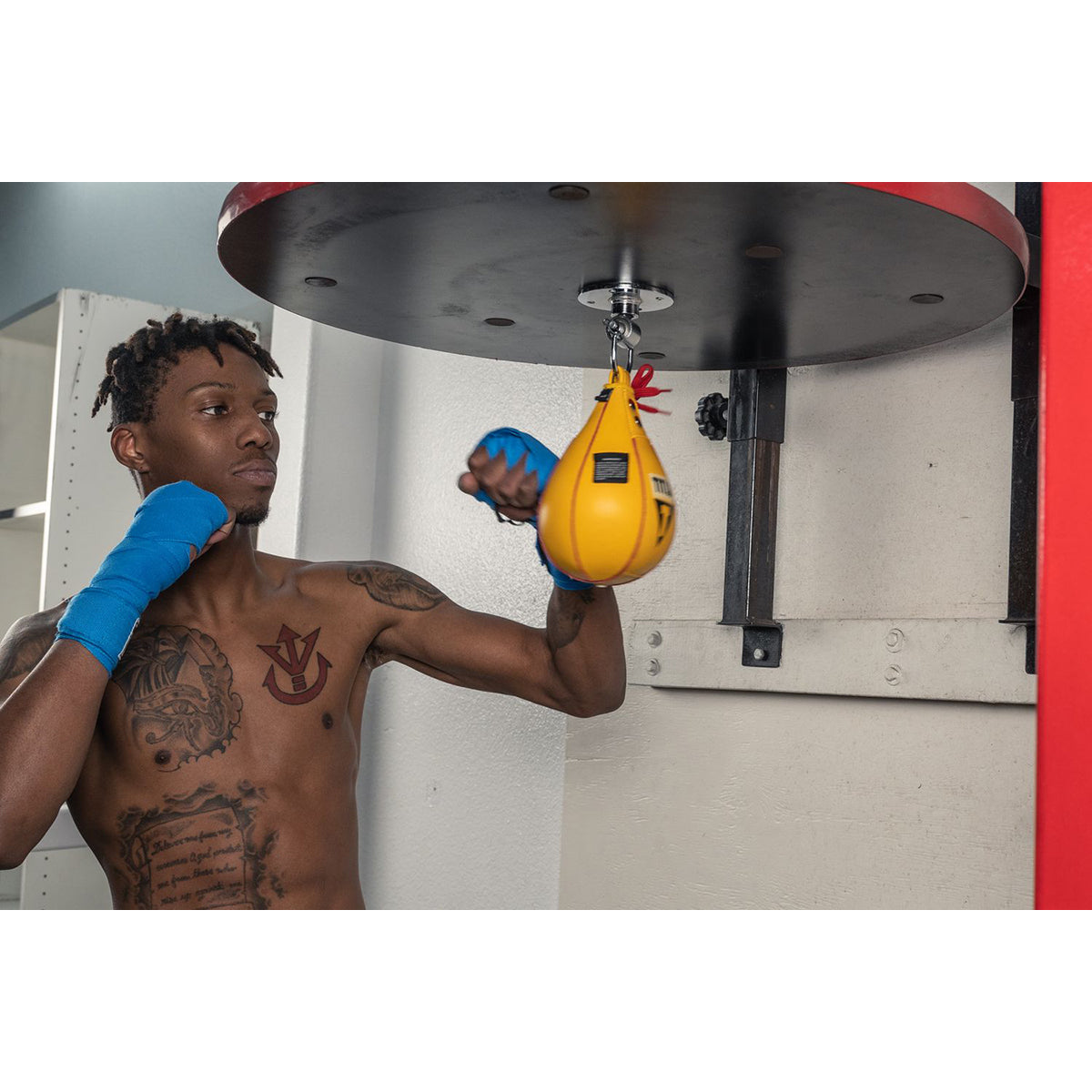 Person training with a Title Boxing Leather Speed Bag in a gym setting
