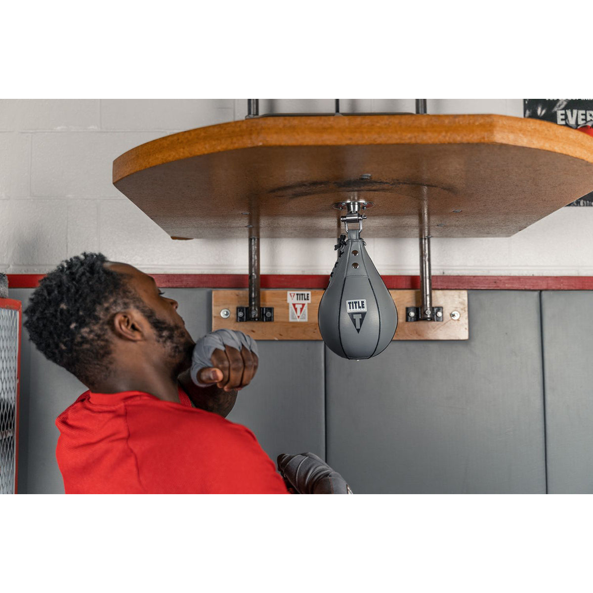 Person training with a speed bag in a gym setting - Title Boxing Leather Speed Bag