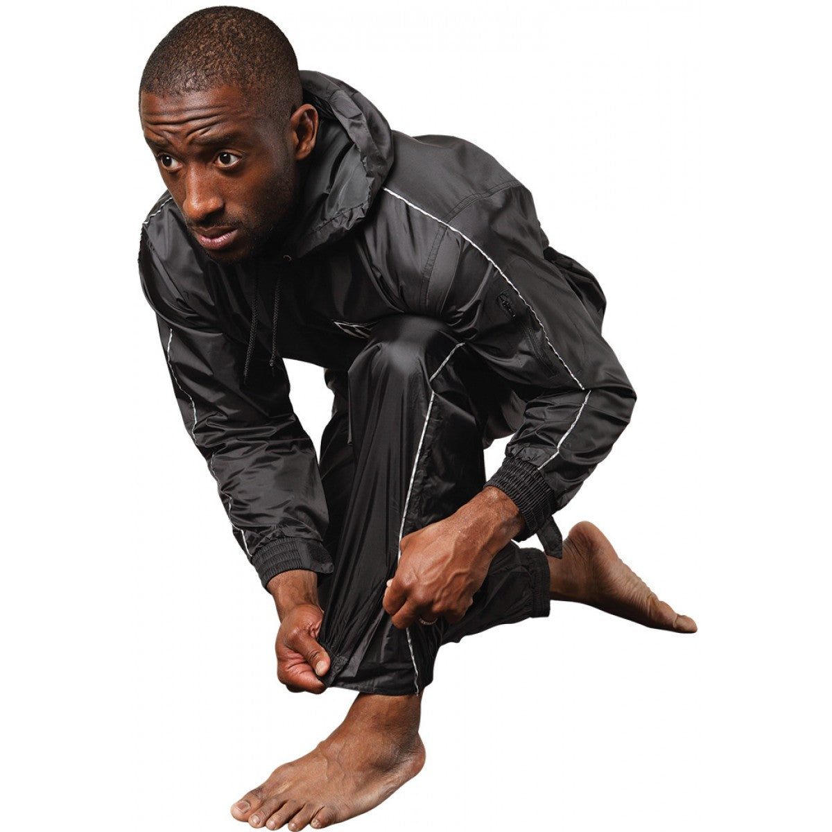 Man wearing a black raincoat and pants on a white background