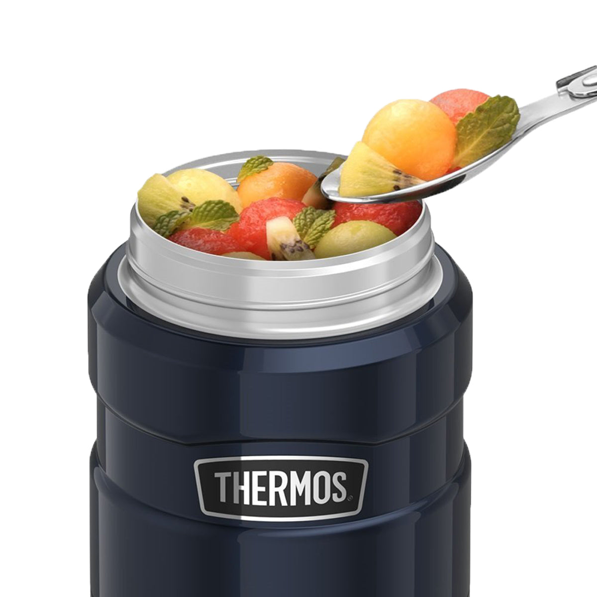 Navy blue Thermos filled with fruits and a spoon on a white background