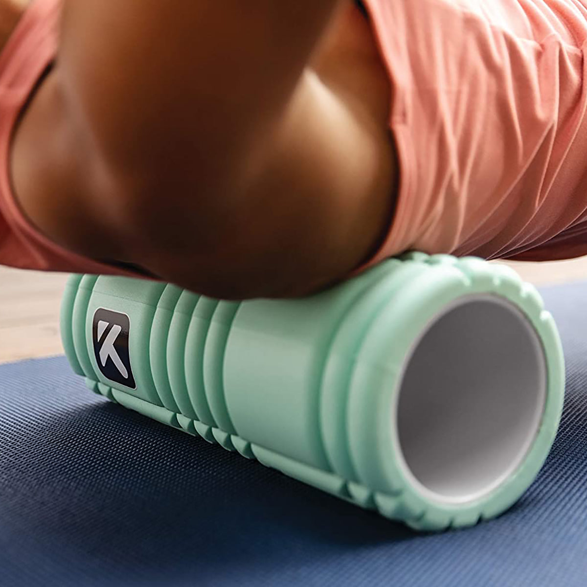 Person using a mint olor portable massage roller - Forza Sports