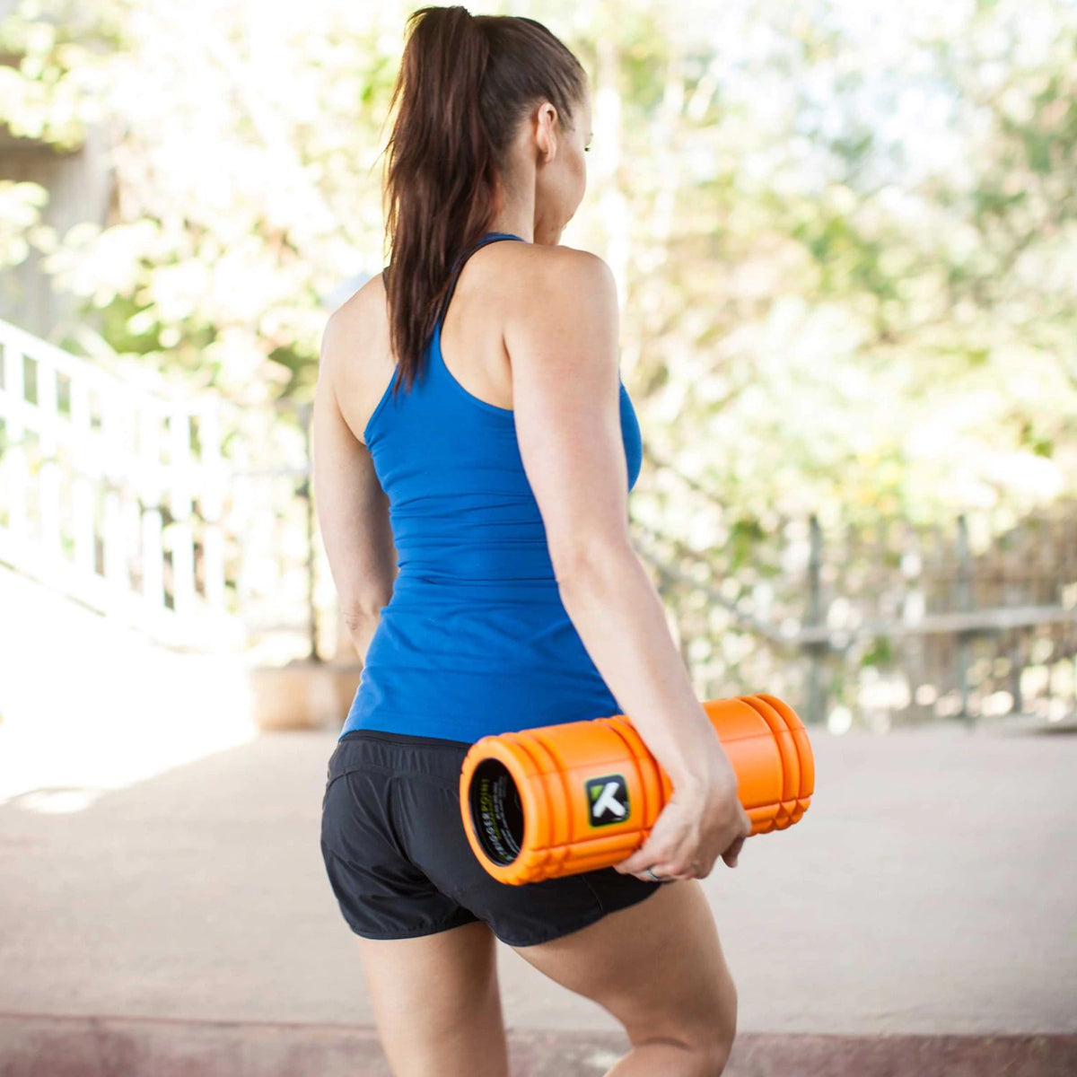 Woman holding an portable massage roller - Forza Sports