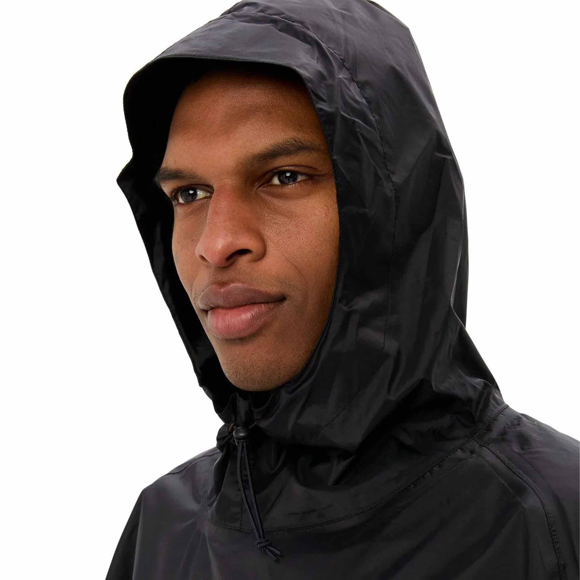 Person wearing a black hooded biking rain jacket on a white background