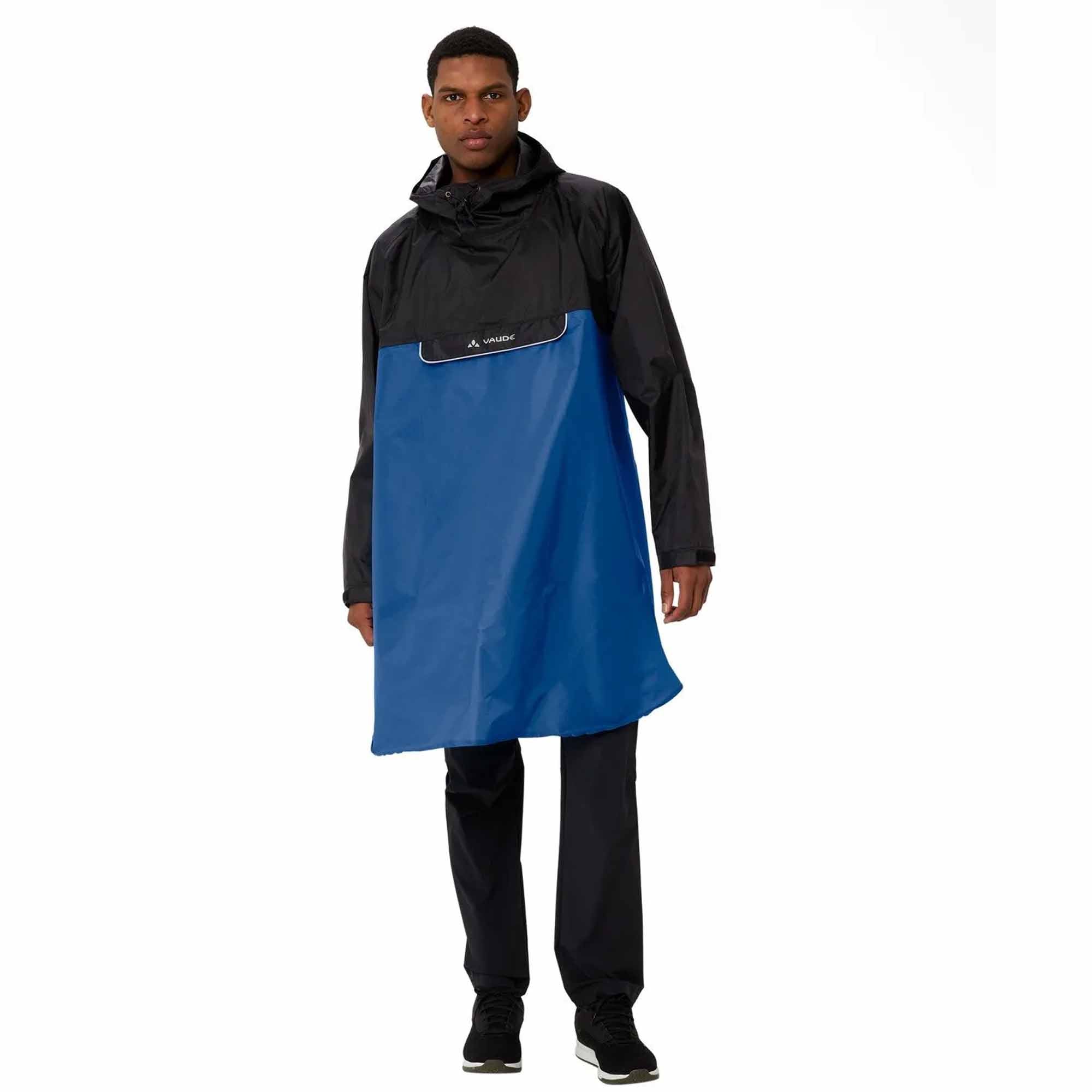 Person wearing a black biking rain poncho with a blue rain披 on a white background